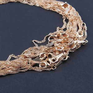 Close-up of 18KGF rose gold water wave chain necklace with lobster clasp detail
