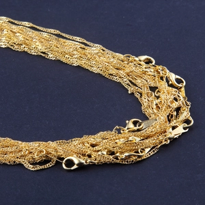 Macro detail of gold-plated water wave chain necklaces with secure lobster clasps