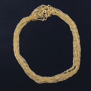 Close-up of gold plated 18KGP water wave chains with lobster clasps on black background