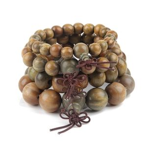 Close-up of polished natural wood prayer beads with traditional hand-woven Chinese knots