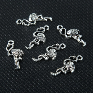 Detailed view of six vintage silver flamingo charms for DIY jewelry making