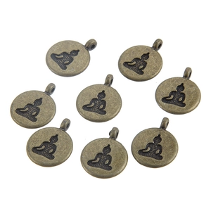 Detailed macro view of 8 vintage bronze Buddha charms for DIY jewelry making