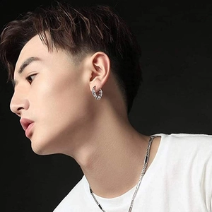 Retro silver hoop earring for men with punk texture on a male model with black background