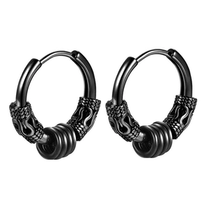 Detail of matte black punk earrings with snake scale texture and three small ring charms
