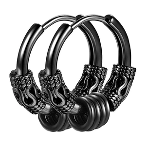 Macro shot of black vintage gothic steel hoop earring with textured scales and small rings