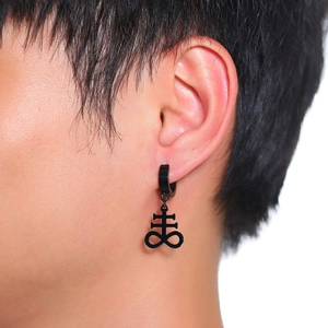 Close-up of black matte stainless steel huggie earring with Leviathan Cross pendant