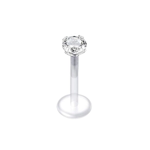 Macro shot of labret piercing with clear bioflex bar and silver claw-set zircon stone