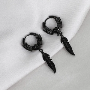 Fashionable black stainless steel hoop earrings with detailed feather pendants on silk