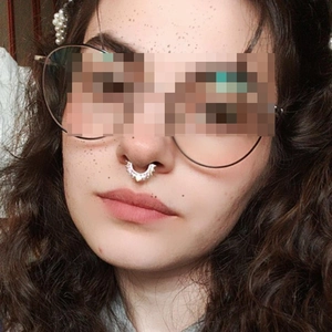 Septum ring horseshoe design with crystal stud row on model for facial jewelry display