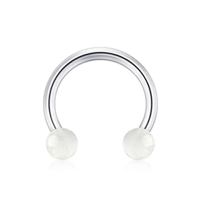 Detail of horseshoe nose ring with silver metal bar and white semi-transparent beads