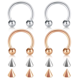 Detailed set of horseshoe piercing rings with interchangeable ball and spike ends in polished steel