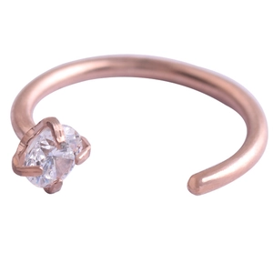 Close-up of rose gold C-shaped stainless steel nose ring with four-prong zircon setting