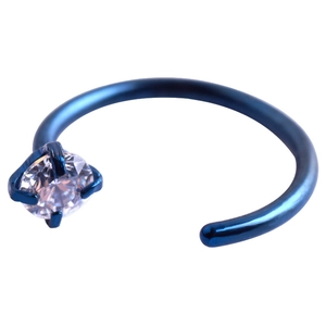 Detail of C-shaped blue stainless steel nose ring with a claw-set clear zircon stone