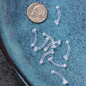 Transparent flexible acrylic eyebrow piercing retainers set with scale coin reference