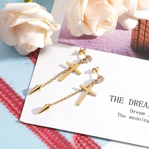 Gold cross earrings with shiny crystals and long chain cone pendants on a card