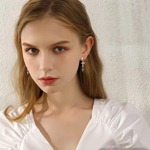 Silver cross earrings with zircon studs and long chain pendant for a modern gothic look