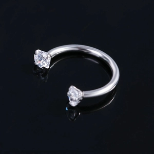 Macro view of circular barbell horseshoe ring with shiny silver finish and cubic zirconia