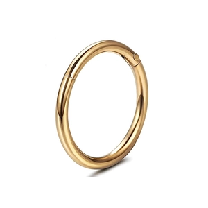 Close-up of polished gold-plated stainless steel seamless clicker hoop for nose or ear