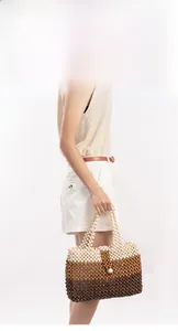 Detail of handmade woven tote bag featuring tricolor wooden beads in cream and brown
