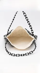 Detail of beaded shoulder bag interior with canvas lining and daily essentials