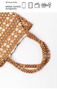 Detail of brown wood bead woven handbag with inner lining showing storage capacity