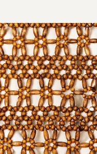 Detailed close-up of hand-woven natural wooden beads pattern on a summer beach tote bag