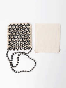 Handmade beaded crossbody bag with geometric flower patterns and drawstring canvas pouch