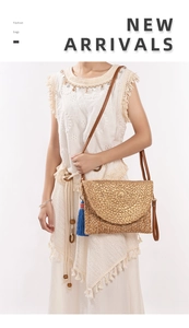 Detail of handmade woven jute shoulder bag with metallic gold flap and blue tassel