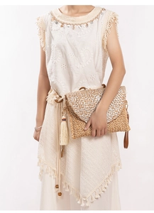 Detail of silver woven texture on handmade jute clutch bag with natural straw fibers