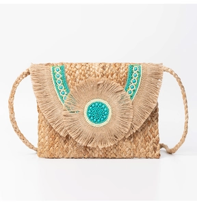 Detailed view of bohemian jute bag with turquoise beads and layered fringe tassels