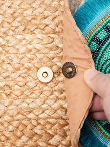 Ethnic jute woven clutch with blue tassels and colorful bead accents for beach vacation