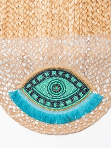Handmade jute woven crossbody bag with evil eye beadwork and blue tassel charm