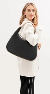 Detail of vintage fluffy shoulder bag with black leather and white plush trim contrast