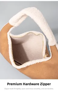 Detailed close-up of smooth gold zipper and soft sherpa trim on the brown vintage bag