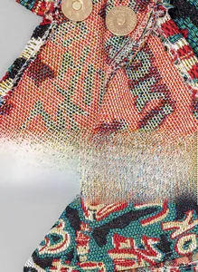 Detail of bohemian woven handbag featuring colorful textures and gold metal magnetic snaps