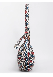 Detail of bohemian canvas bag featuring geometric ethnic patterns and a wooden ring connector