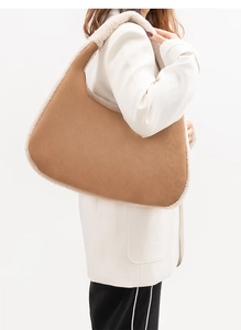 Detail of vintage brown suede shoulder bag with plush fleece trim for autumn and winter