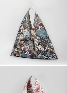 Detail view of triangular tote bags with bohemian patterns and butterfly prints