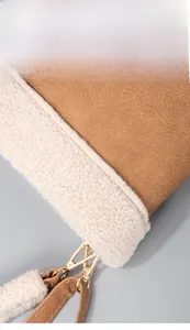 Detail of brown litchi PU leather and white fleece texture with gold metal hardware