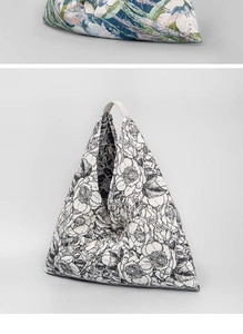 Detailed macro view of bohemian floral print on a triangular fabric hobo shoulder bag