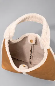 Detail shot of the large opening design and magnetic snap closure on the fleece handbag