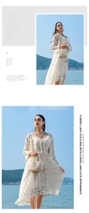 Close-up of white handmade beaded bucket bag with elegant side tassel and woven texture