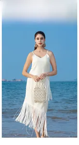 Detail of hollow geometric mesh design on a woven wooden bead handbag for beach vacations