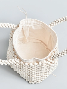 Beaded bucket bag with woven drawstring liner and handcrafted wood bead top handle