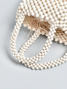 Handcrafted cream beaded bucket bag with drawstring liner and textured round beads
