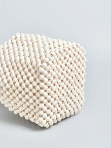Handmade cream beaded bucket bag with intricate woven wooden bead texture and bucket shape