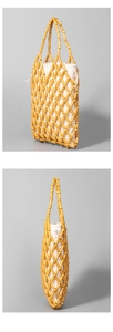 Close-up of the hollowed-out wooden bead weaving and drawstring canvas inner lining bag