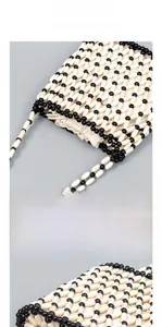 Detailed macro view of handcrafted wooden bead weaving and internal canvas liner bag