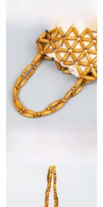 Detailed view of handcrafted wooden bead weaving and natural linen lining on tote bag