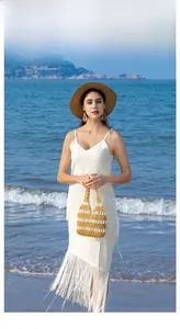 Detail of handmade hollow wood bead handbag with yellow and white stripes for beach holidays